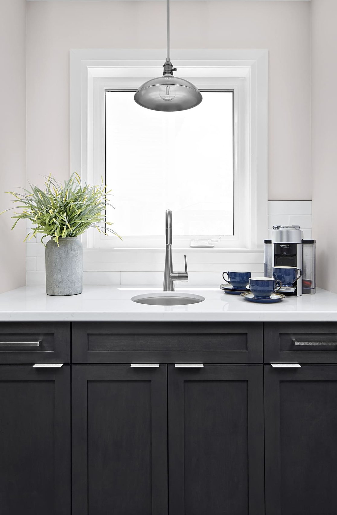 Custom coffee bar area with under mount sink and Espresso machine with cabinet storage