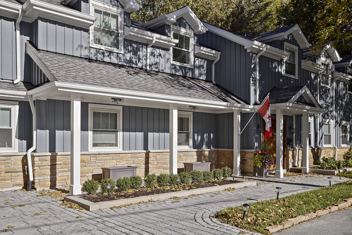 Front view of Muskoka cottage renovation with white porch posts
