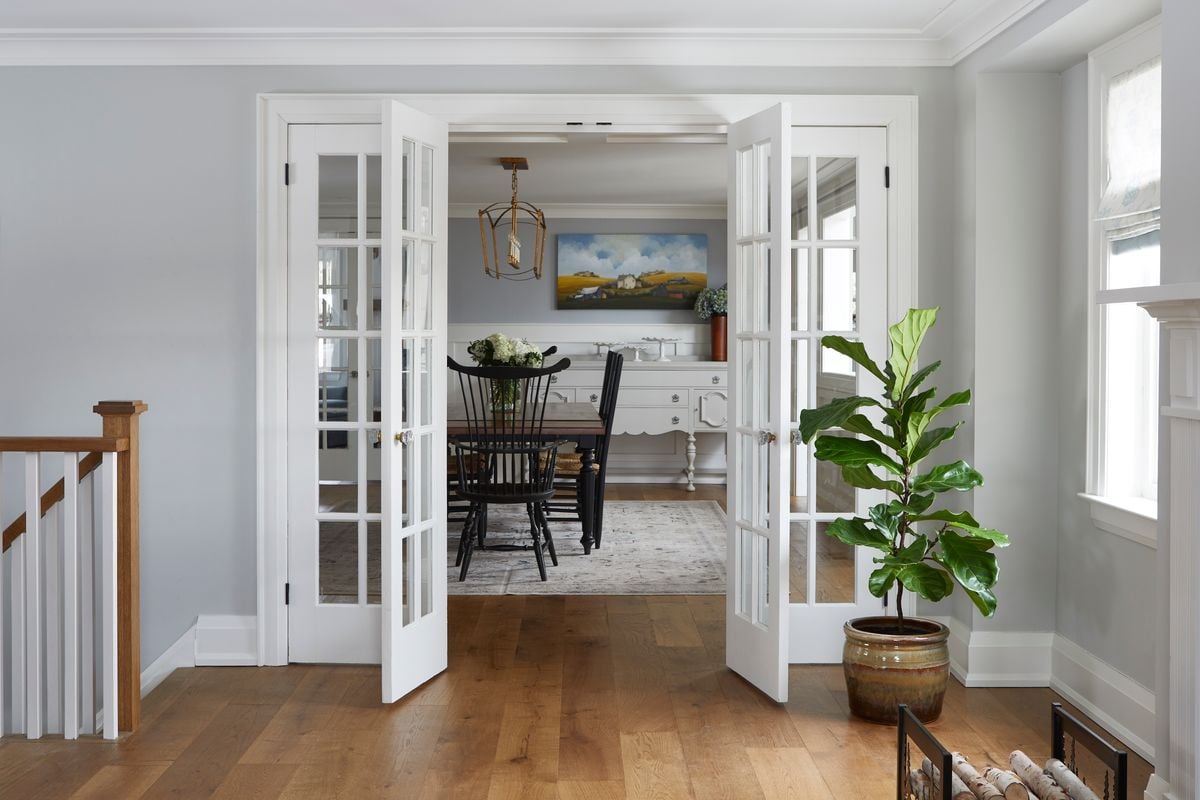 Hallway-into-dining-room-with-plant-next-to-white-french-doors
