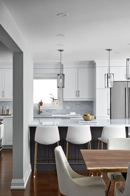 Luxury kitchen renovation in Markham with three white stools at island by Master Edge Homes