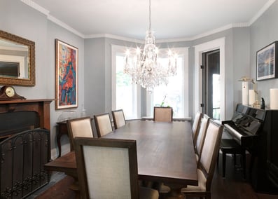 Transitional dining room with chandelier above table 