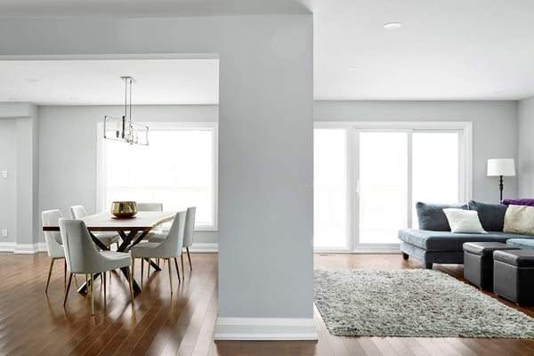 View of living and dining room in Markham home renovation by Master edge Homes with natural light from windows