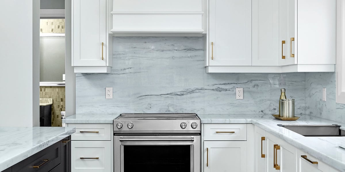 Luxury natural stone backsplash with white shaker cabinets in Markham kitchen renovation