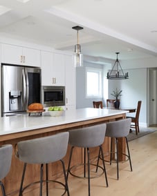 Quartz kitchen island with hanging glass pendant above in Markham kitchen renovation