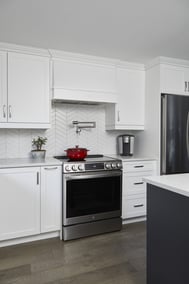 Range hood and oven with built-in pot filler on chevron backsplash in Markham