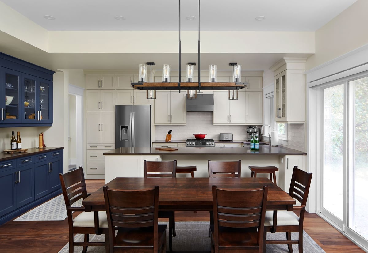 Renovated kitchen with blue cabinets and dining room table in Markham renovation