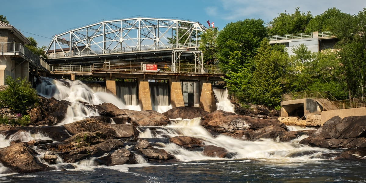 Water rushing through dam on sunny day at Bracebridge Falls