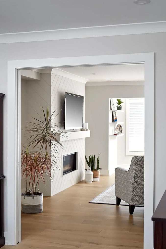 White modern home renovation in Loweswater, Markham with fireplace and hardwood flooring