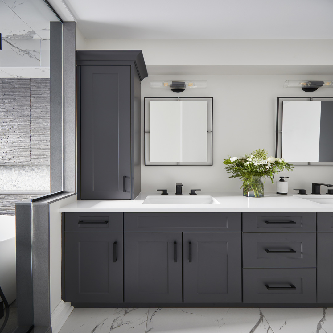 Bathroom ensuite with gray cabinets and black faucet fixtures