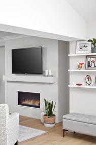built in fireplace with floating tv above in modern markham home renovation