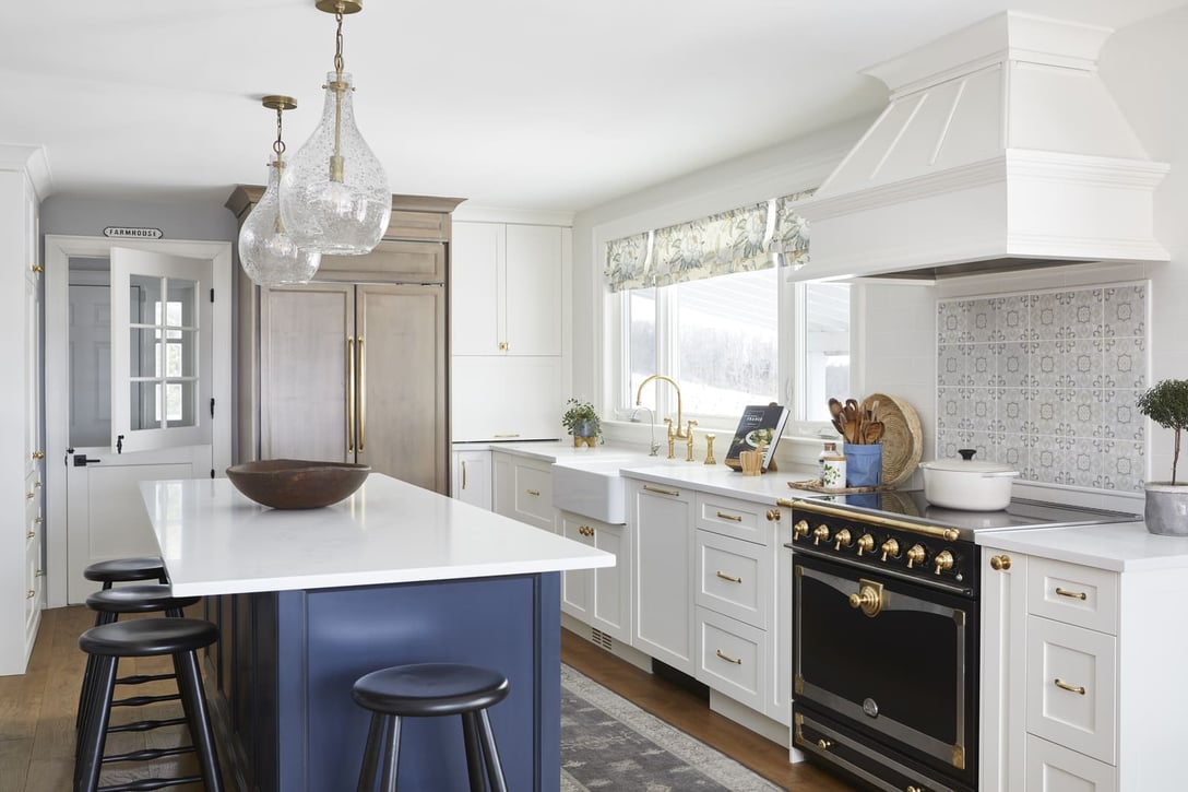 Cottage kitchen renovation with kitchen island beneath light fixtures