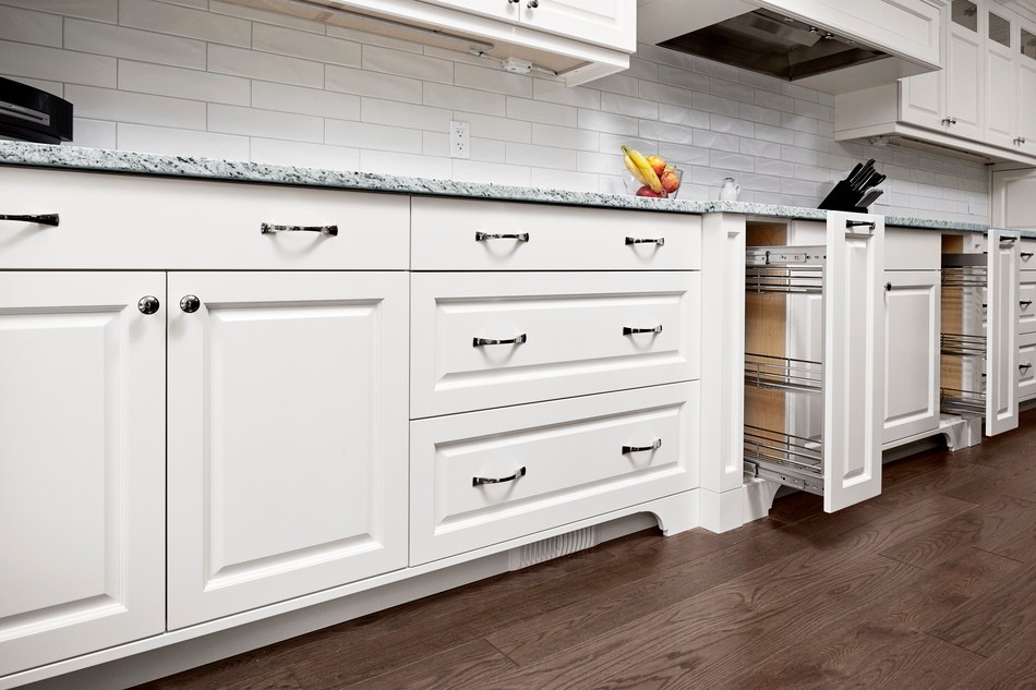 Custom cabinetry with pull out kitchen spice drawers