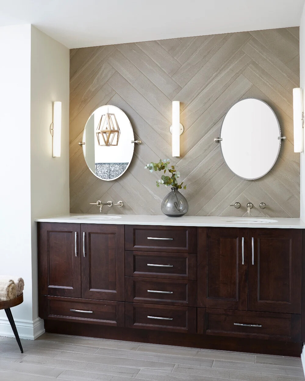 ensuite bathroom vanity with herringbone backsplash and subway tile flooring