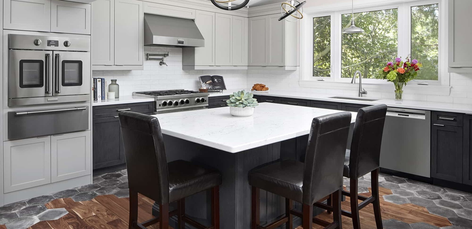 kitchen renovation with island and chairs on hexagonal tile flooring