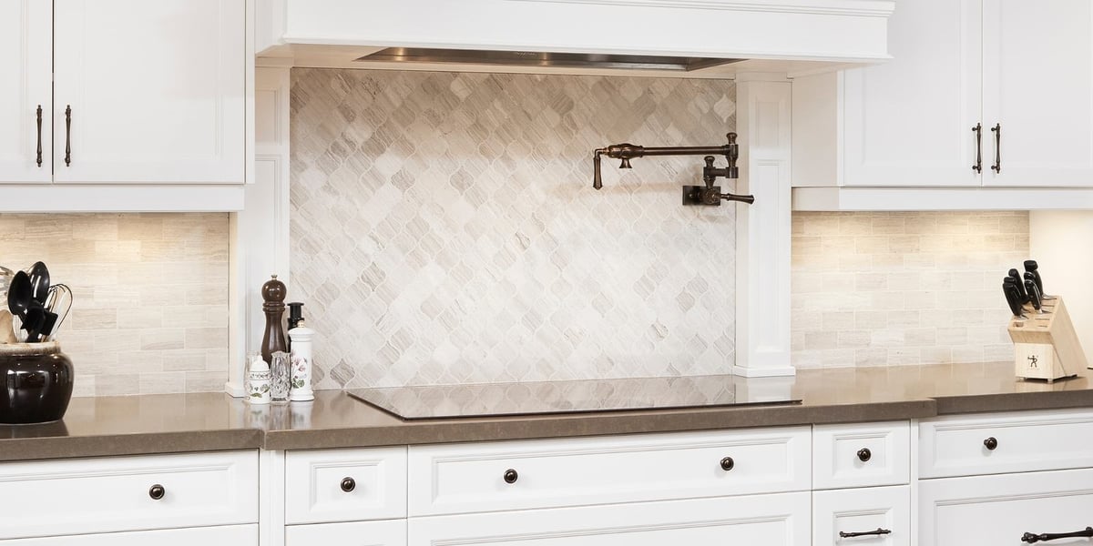 Luxury kitchen tile backsplash beneath range hood