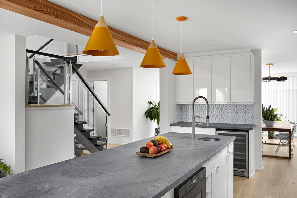 Modern kitchen renovation with bold light fixtures above island