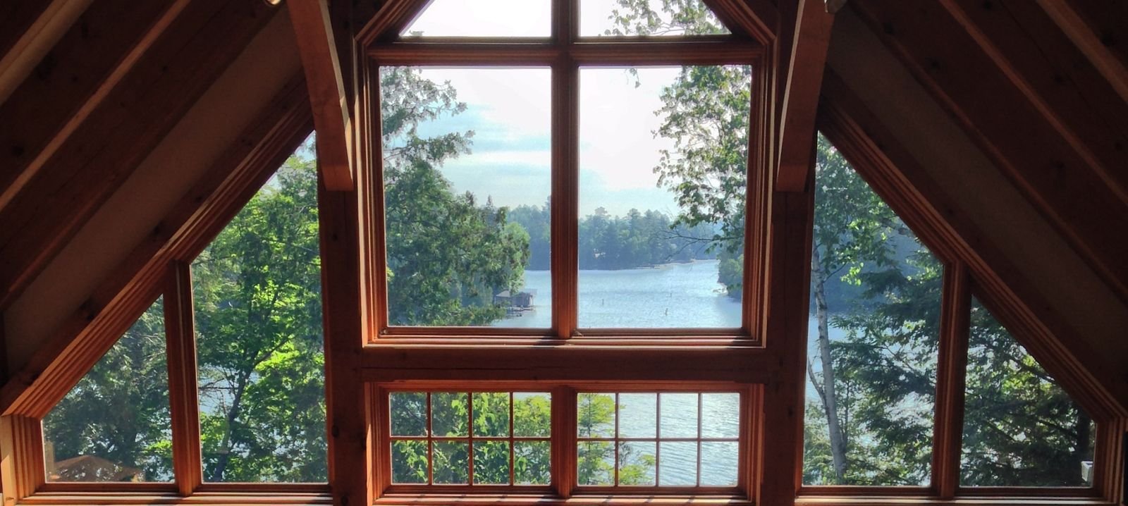 muskoka cottage vaulted ceiling looking out windows to lake