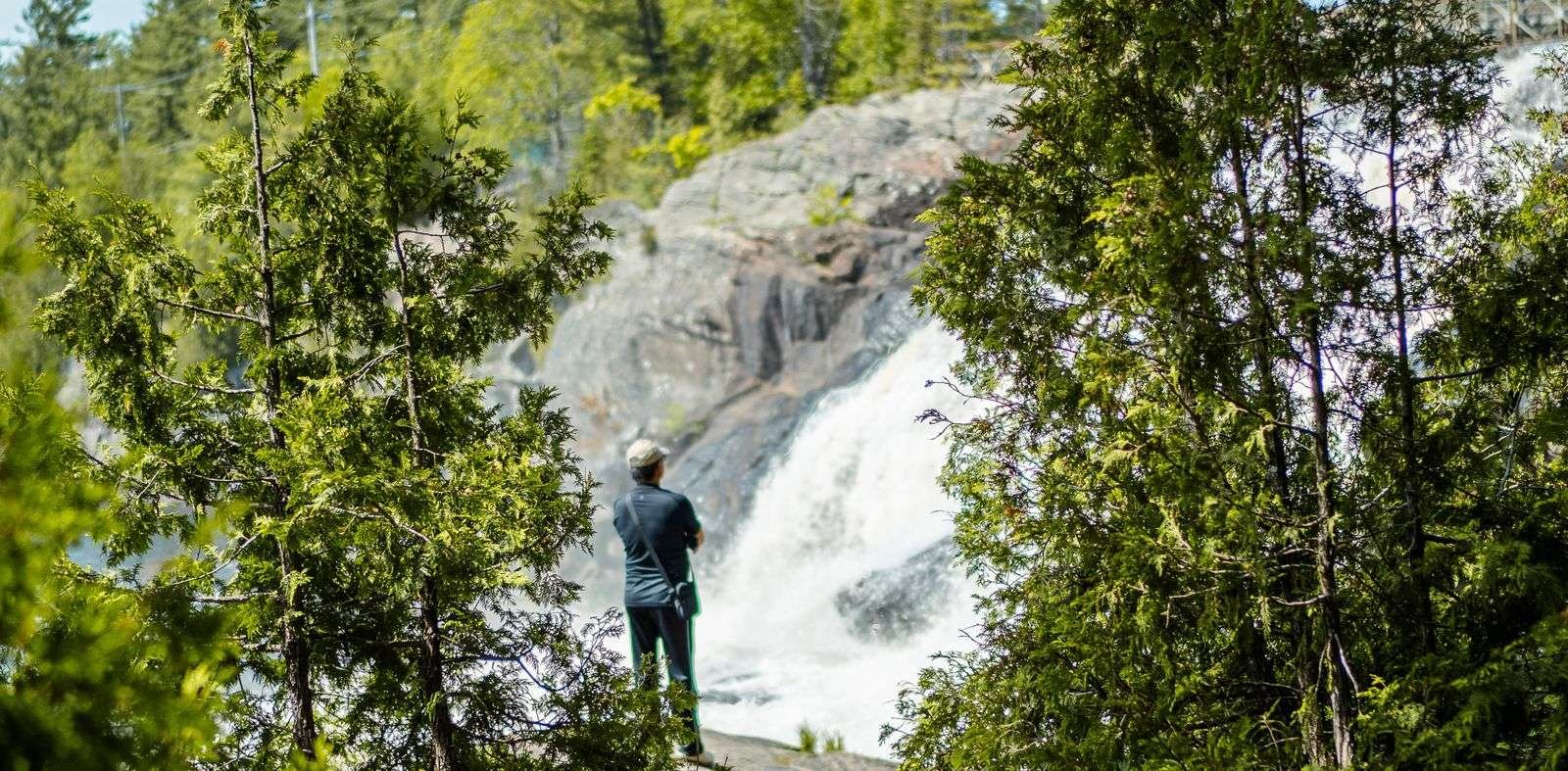 muskoka falls man standing looking at waterfall in muskoka things to do (1)