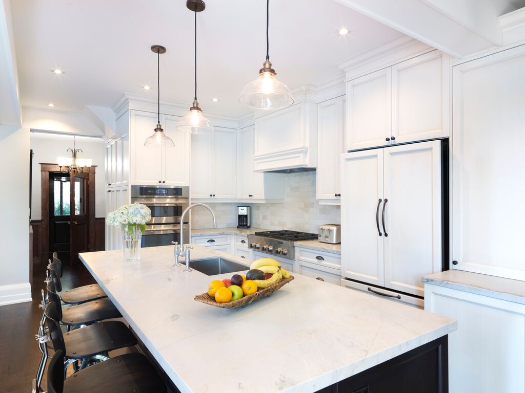 Newly renovated kitchen near front door with island seating 