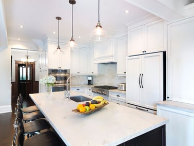 Newly renovated kitchen near front door with island seating 