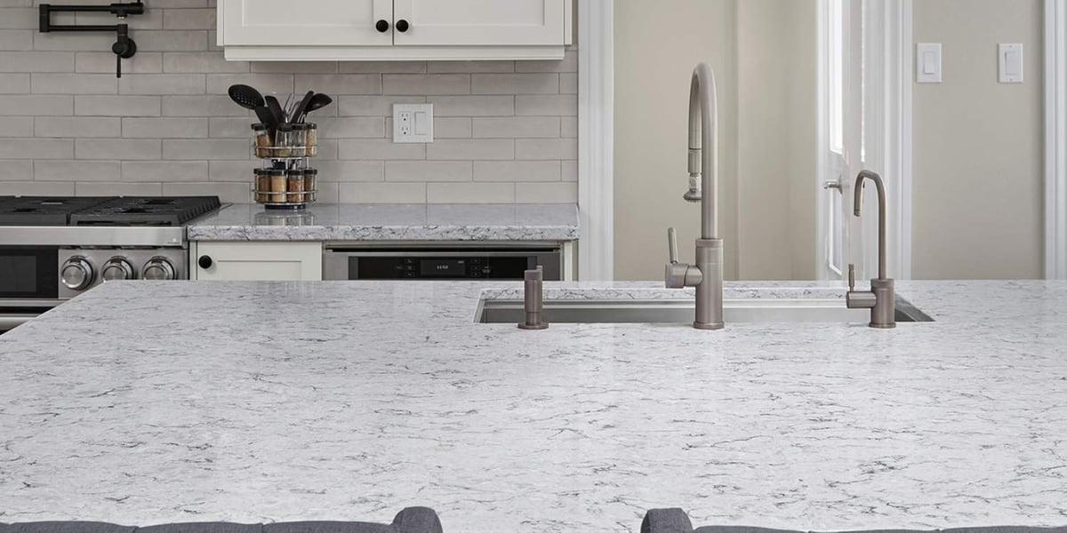 Quartz countertop on kitchen island with stainless steel under mount sink