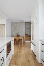 white modern kitchen renovation with stone accent wall and dinner table in markham2
