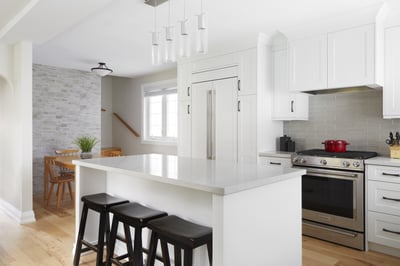 white modern kitchen renovation with white kitchen island and stone accent wall in markham
