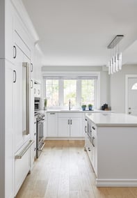 white modern kitchen renovation with white kitchen island looking at sink in markham