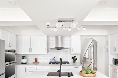 white modern kitchen with herringbone style backsplash blue island and barstools in markham renovation2