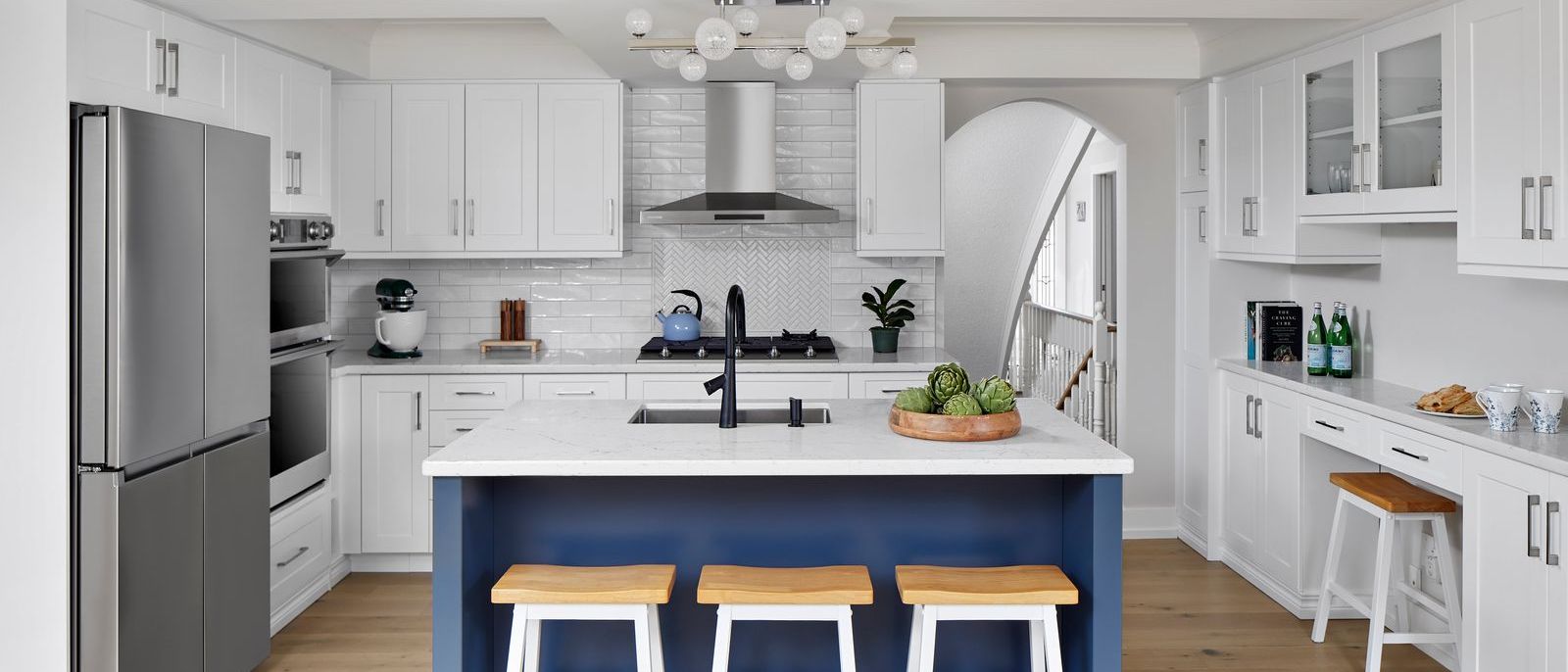 white modern kitchen with herringbone style backsplash blue island and barstools in markham universal designed renovation