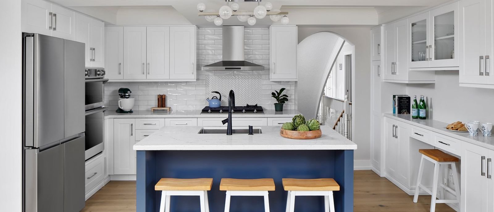 white modern kitchen with herringbone style backsplash blue island and barstools in markham universal designed renovation