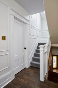 white walkway to stairs and wainscotted walls in markham home renovation