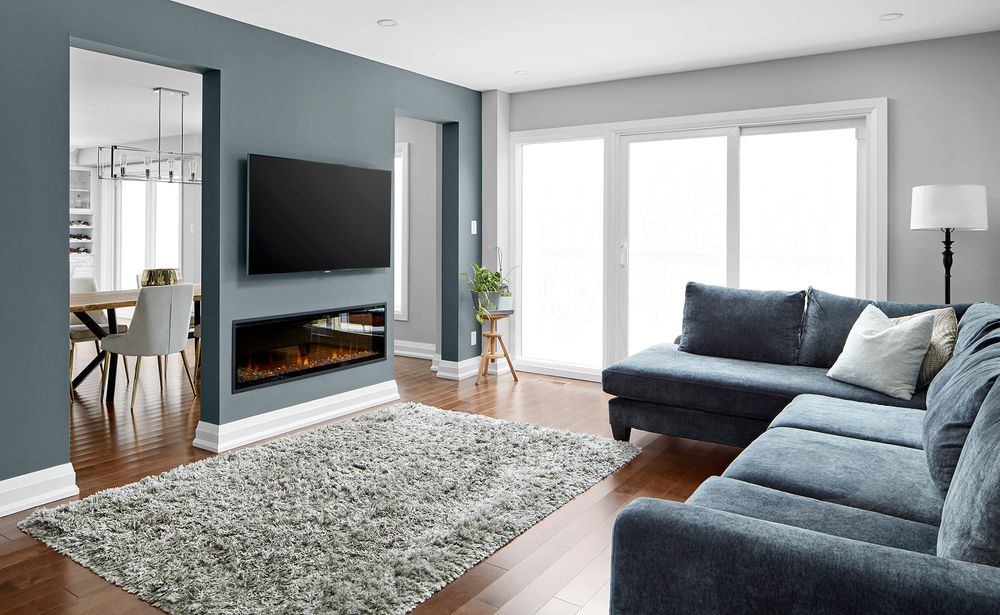 markham home renovation costs living room with tv on wall and fireplace