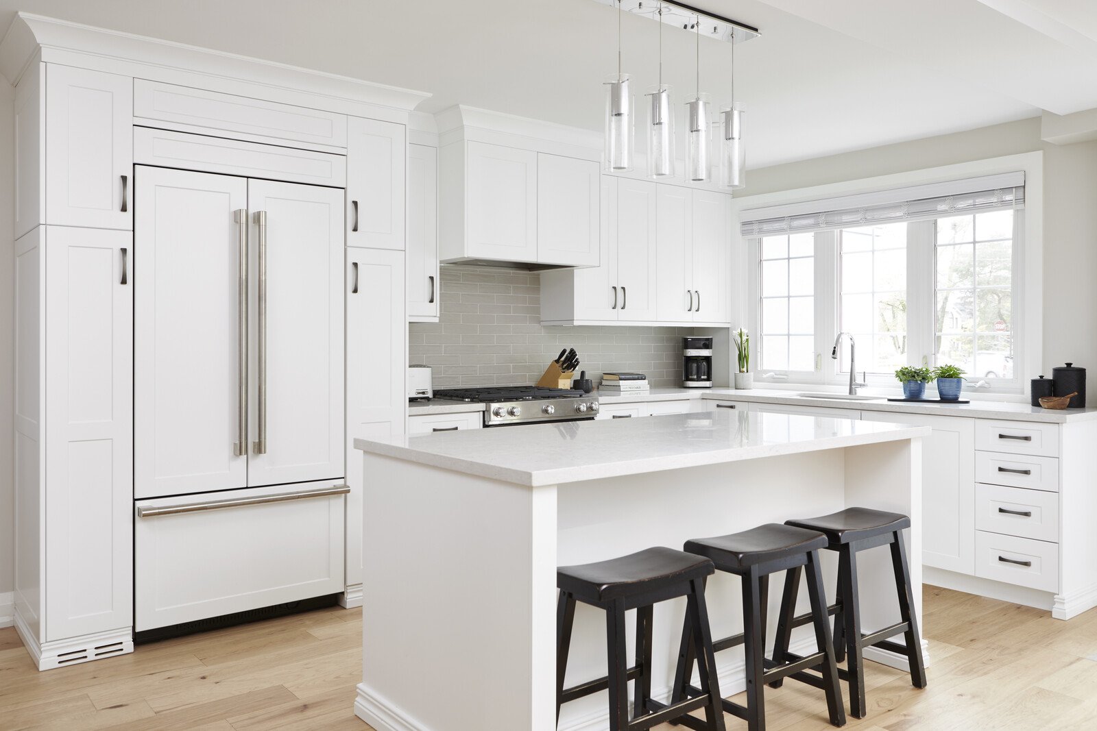 white modern kitchen renovation with white kitchen island tiled backsplash in markham